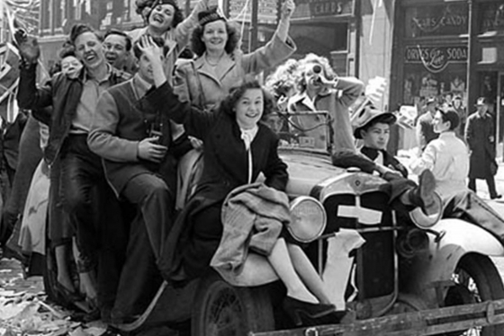 Black and white photo of a group of Canadians riding a car together at the time of the second world war